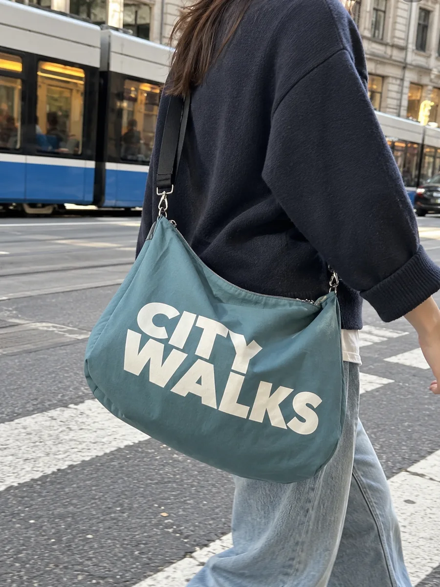 Teal bag, white "CITY WALKS" print, on the shoulder