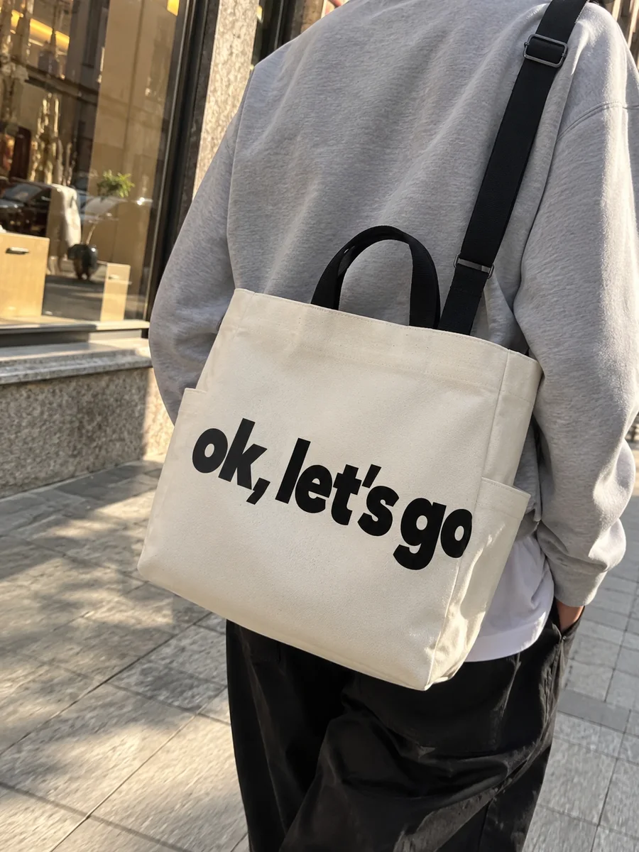 "ok, let's go" print, black strap, on the shoulder