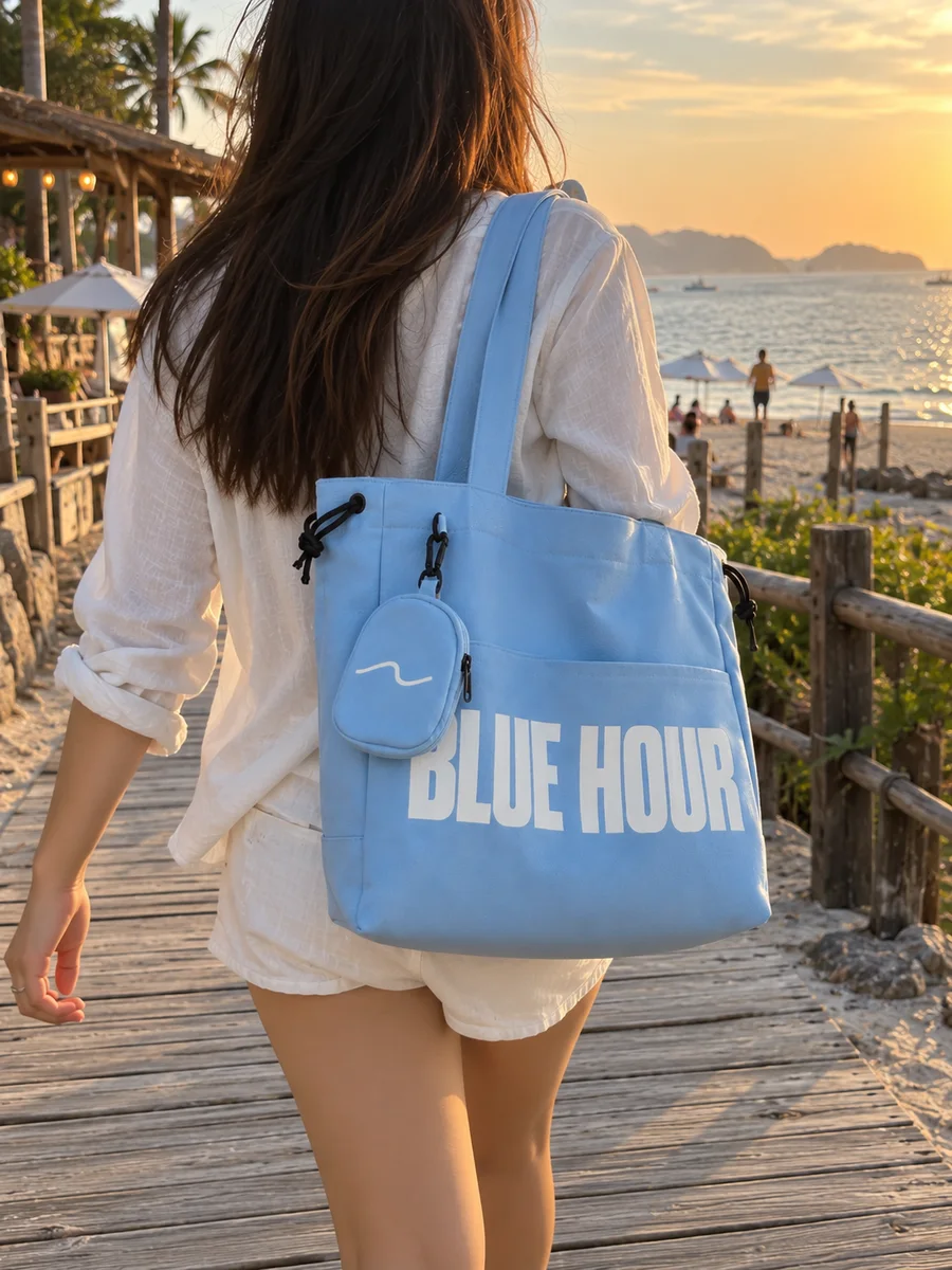 Light-blue bag, white "BLUE HOUR" print, from behind