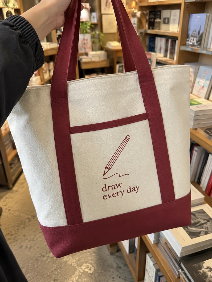 "draw every day" line-art print, burgundy trim, close-up